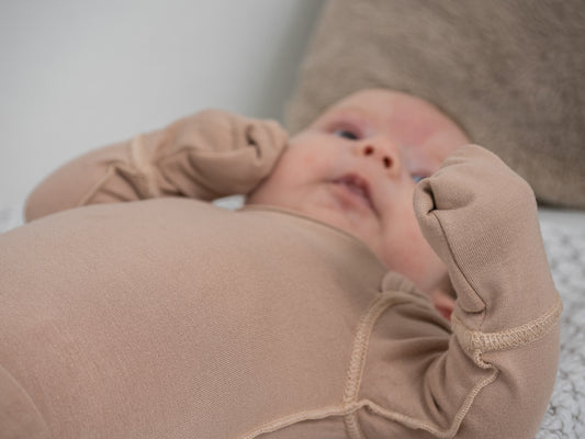 Baby With Eczema On Face Wearing Allergy-friendly Baby Bodysuit With Anti-scratch Mittens From SOOTHLA.